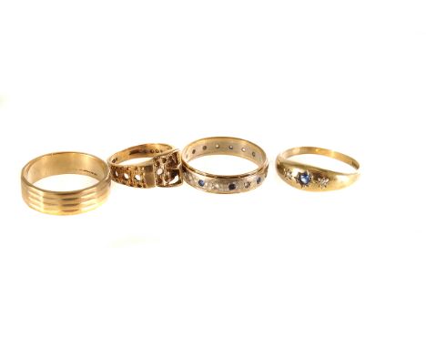 Four 9ct gold rings, including a gem set eternity ring, a buckle ring, another gem set example and a band, approx. 9.5g 