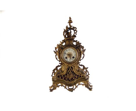A Louis XV style gilt painted mantle clock, having Arabic numerals to enamel dial, 8 day movement, with acanthus leaf swag de