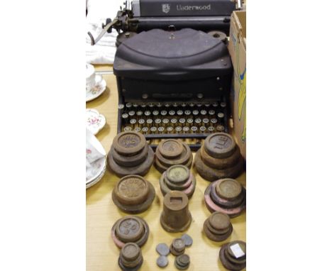 An Underwood typewriter; assorted graduated weights for balance scales; qty
