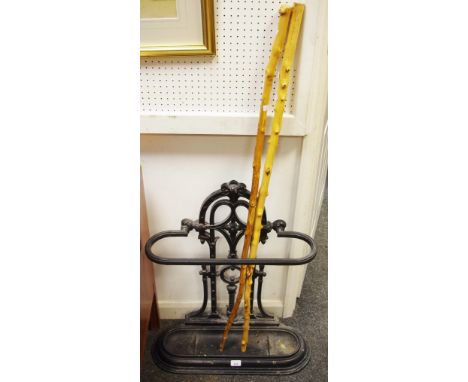 A cast iron stick stand and two Hedgerow walking sticks