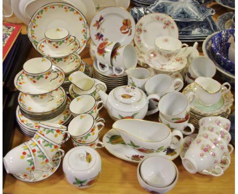 A Royal Doulton tea set, enamelled with bright fruits and leafy stems, Reg No. 722922, a Royal Worcester Evesham pattern tea 