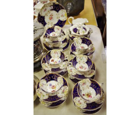 A Coalport part tea service in cobalt blue and gilt with floral decoration.