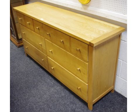 A G-Plan light oak sideboard of six long drawers, the top two in the form of three faux drawers