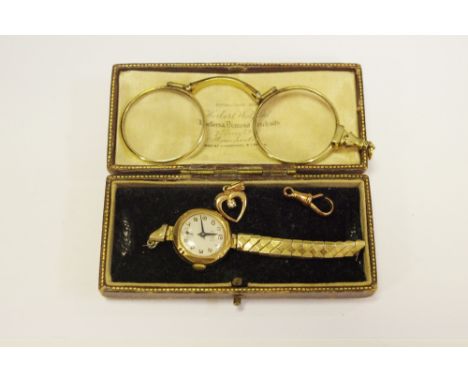 A pair of folding lorgnette; a 9ct gold lady's watch, later metal strap; a 9ct rose gold fastener; a pendant with stone (4)