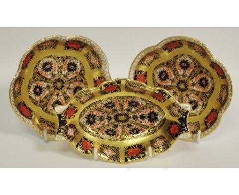 A Royal Crown Derby shaped oval trinket dish, all gold border; two similar shaped circular