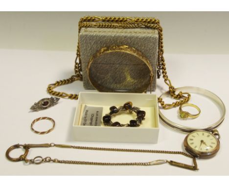 A solid silver hinged bangle, gilded 37.9g; a silver bangle 23.5g; a silver and marcasite brooch set with a central oval red 