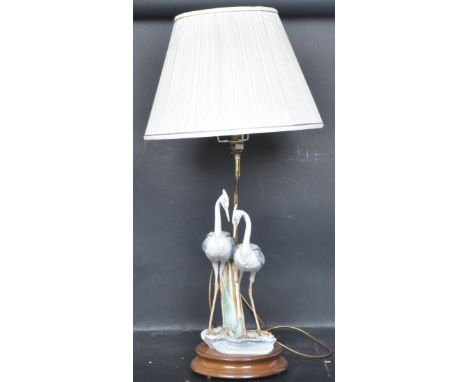 Capodimonte - A vintage 20th century Italian table lamp having two herons raised on a circular wooden base. Measures 80cm hig