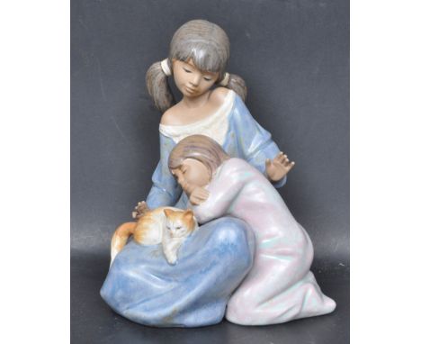 A ceramic porcelain Spanish Lladro figure entitled 'Little Sister'. Figurine model number 12261 / 2261. Complete with origina