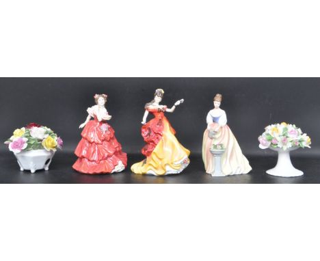 A group of three Royal Doulton ceramic porcelain figurines. The collection to include “ Joy “ HN4054, Belle HN3703, Alexandra