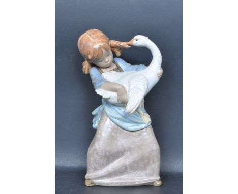 A ceramic porcelain Spanish Lladro figure entitled 'Duck Pulling Pigtail'. Figurine model number 2095. Complete with presenta