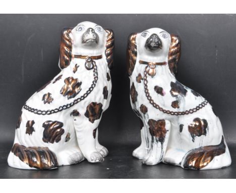 A pair of vintage 20th century ceramic Staffordshire dogs having hand painted polychrome decoration. Measures 25cm high.