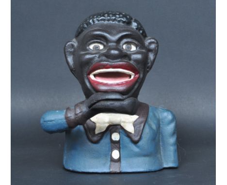 A vintage style cast metal novelty negro mechanical money bank having an articulated arm with polychrome paint decoration. Me
