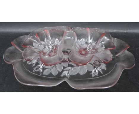 A vintage retro 20th century pressed pink glass dressing table set in the manner of Lalique. The set comprising of a twin mou