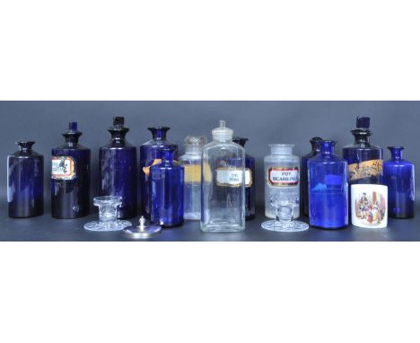 A large collection of vintage retro 20th century glass chemist bottles. The collection include blue glass bottles and clear g