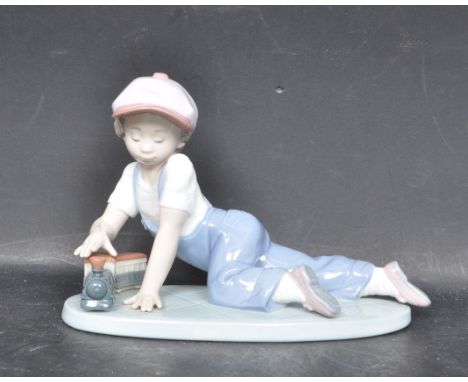 A ceramic porcelain Spanish Lladro Collectors Society 1992 figurine entitled 'All Aboard' depicting a young boy playing with 