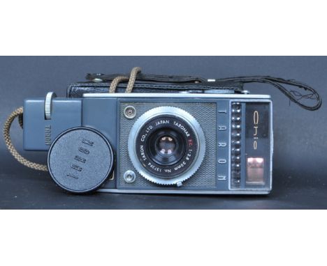 A retro vintage mid 20th century Chic Taron 35mm vertically oriented half frame camera having a 30mm f/28 lens. Comes with le