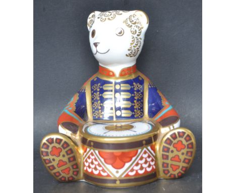 A Royal Crown Derby porcelain ceramic 'Drummer Teddy Bear' paperweight (LXII). Makers mark to base and complete with gold sto