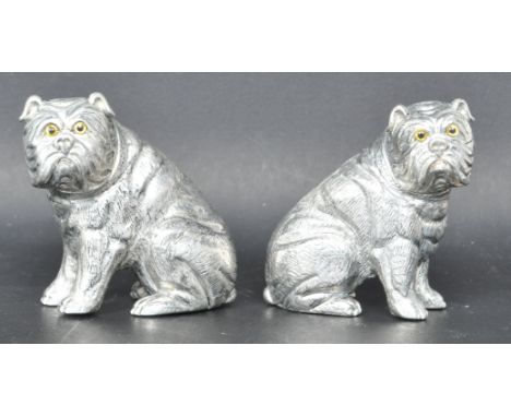A pair of vintage style salt and pepper shakers in the form of a Bulldog stamped 800 to the base. Having glass yellow eyes. M