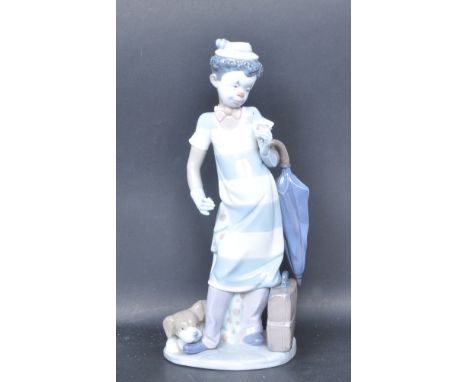 A ceramic porcelain Spanish Lladro figure entitled 'On The Move' depicting a clown with umbrella. Figurine model number 5838.