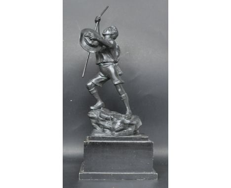 A vintage mid 20th century bronzed spelter Scouts trophy / figurine of a young boy scout reaching the peak of a mountain rais