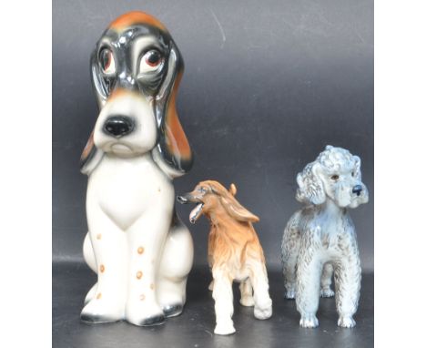 A group of three vintage 20th century ceramic porcelain dog figurines to include a Royal Doulton dog figurine West German Goe