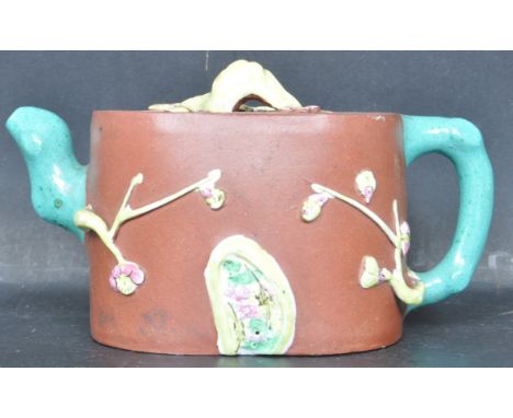 A vintage 20th century Yi Xing Chinese Oriental ceramic pottery teapot having glazed naturalistic embellishments. Makers stam