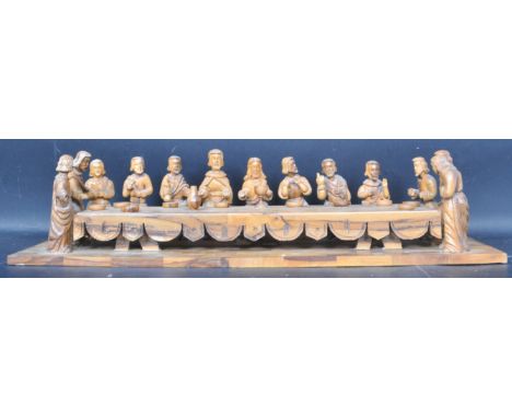 A vintage 20th century carved hardwood centrepiece ornament of The Last Supper having Jesus to the centre surrounded by the A