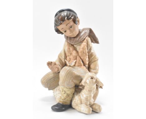 A large ceramic porcelain Spanish Lladro figurines. “ Tender Moment “ 2222 - depicting a boy with a lam. Makers mark to the u