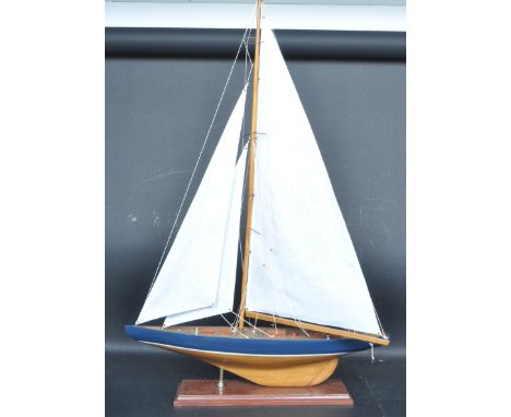 A vintage mid 20th century pond yacht / boat complete with sails, rigging raised on a square base. Measures 90cm high x 65cm 