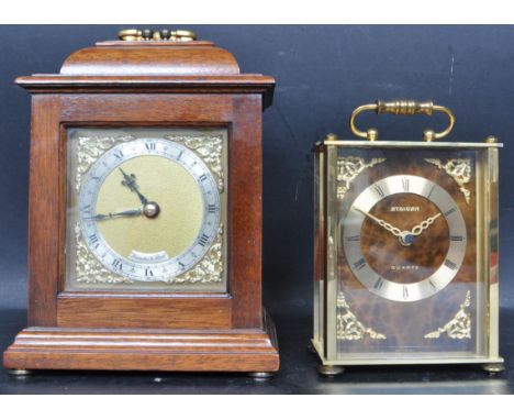A group of two vintage 20th century mantle clocks. The collection includes a brass face mantle clock with Roman numerals to t