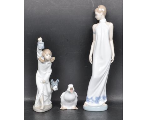 A group of three ceramic porcelain Spanish figurines by Nao. The collection to include a large duck, a girl with dog and lant