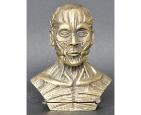 A vintage style brass anatomical figure vesta case having a hinged base &amp; match strike. Measures 7cm tall. Good condition