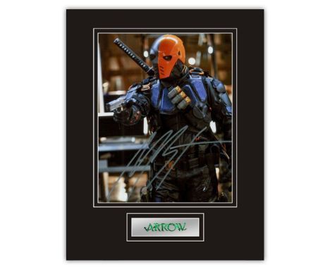 Stunning Display! Arrow Manu Bennett hand signed professionally mounted display. This beautiful display consists of a 10"x8" 