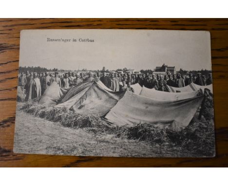 German WWI RP Postcard of Russian Prisoners of War in a P.O.W. Camp in Cottbus, guarded by Soldiers the 52nd Infantry Divisio