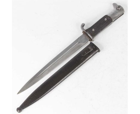 A German Third Reich K98 dress bayonet, having a 25cm single edged fullered blade with chequered two piece grips, housed in a