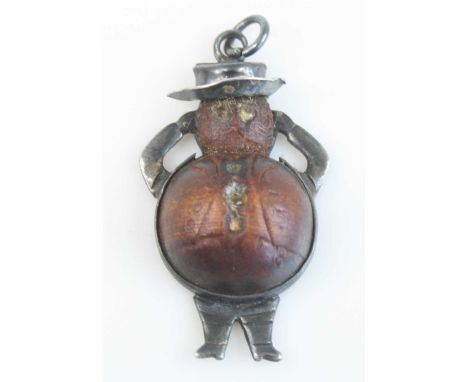 A WW I novelty fumsup / touchwood charm in the form of John Bull, the convex wooden body within a with metal surround with li