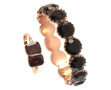 AN ANTIQUE GARNET RINGin 9ct gold, the ring set with two step cut garnets, no assay marks, UK size L / Eu size 51; together w