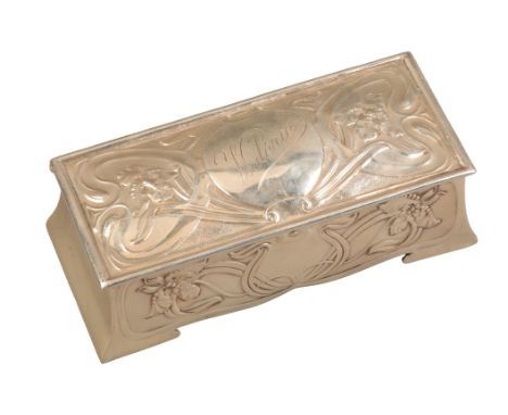 AN ART NOUVEAU SILVER JEWELLERY BOX by William Neale, Chester 1902, of trapezoid shape, the domed cover and sides embossed wi