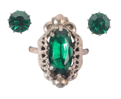 A GREEN PASTE COCKTAIL RING AND EARRINGS SUITEset with a faceted green paste stone to a stylised setting; together with match