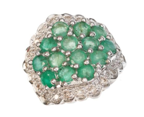 AN EMERALD AND DIAMOND CLUSTER RINGin 14ct white gold, set with a cluster of round cut emeralds, in a border of round brillia