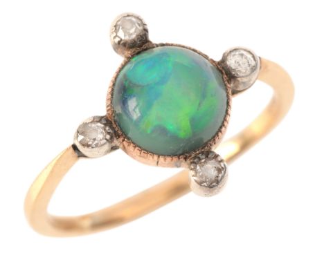 AN OPAL AND DIAMOND RINGin 9ct gold and silver, set with an opal cabochon of c.1.35 carats, accented by four old mine cut dia