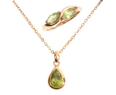 A PERIDOT PENDANT NECKLACEin 18ct gold, the pendant set with a pear cut peridot, held in a bezel setting, suspended from a tr