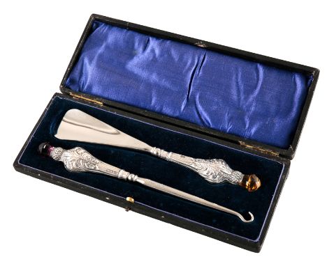 AN EDWARD VII SILVER THISTLE DESIGN BUTTON HOOK AND SHOE HORN SET by Crisford &amp; Norris, Birmingham 1906, the leaf embosse