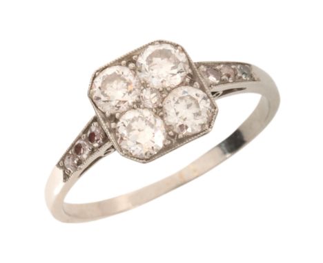 A VINTAGE DIAMOND DRESS RINGin platinum, the head set with four old European cut diamonds, accented by a single cut diamond t
