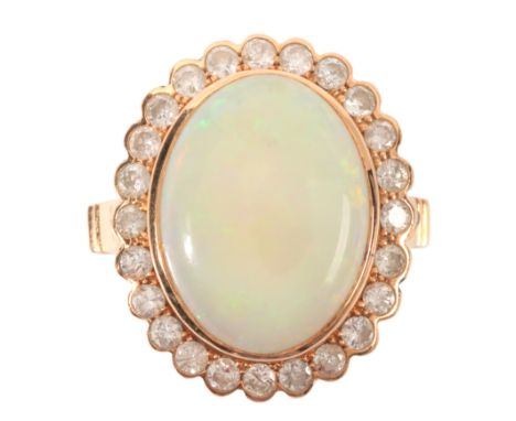 AN OPAL AND DIAMOND CLUSTER RINGin 18ct gold, set with an opal of c.4.32 carats, held in a bezel setting, surrounded by a bor