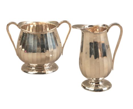 A GEORGE V SILVER BACHELORS PART TEA SERVICEby Goldsmiths & Silversmiths, London 1914, comprising milk jug and sugar bowl wit