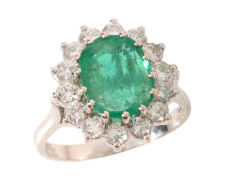 AN EMERALD AND DIAMOND CLUSTER RINGin 18ct white gold, set with an oval cut emerald of c.1.52 carats, in a cluster of round b