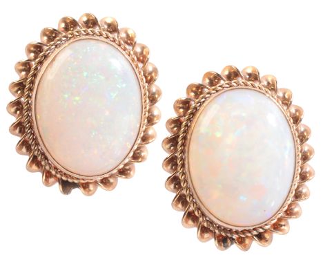 A PAIR OF OPAL STUD EARRINGSin 9ct gold, each set with an opal held in a bezel setting, surrounded by a twisted ropework bord