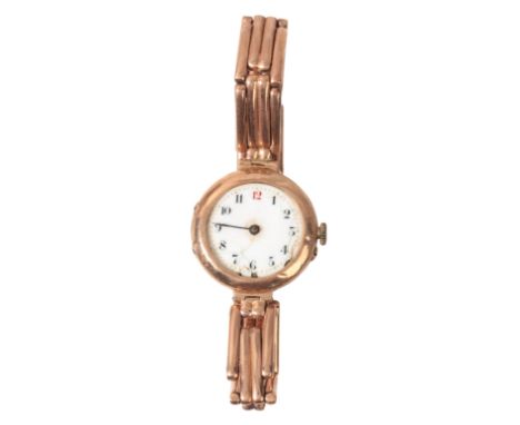 A LADY'S 9CT GOLD BRACELET WATCHwith manual wind movement, the circular white enamel dial with black Arabic numerals and red 