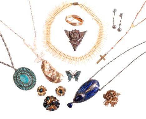 A COLLECTION OF COSTUME JEWELLERYincluding a blue and white paste brooch and earrings suite, a stylised engine-turned brooch,